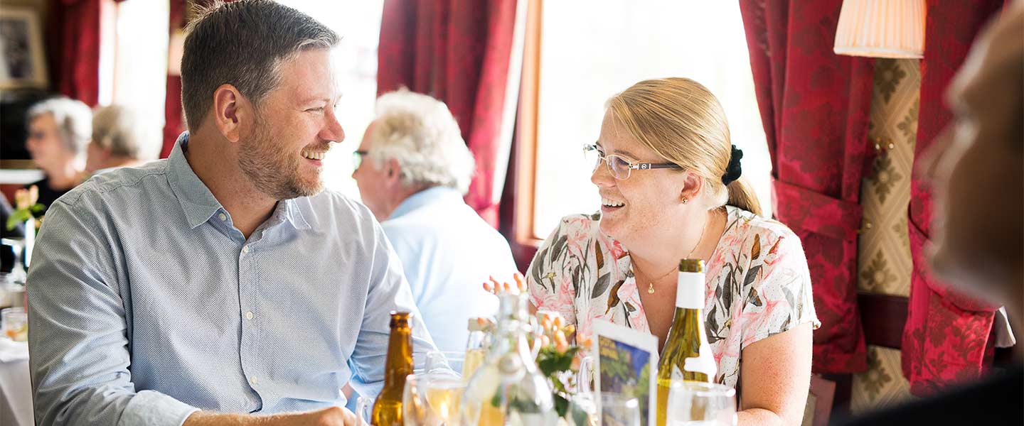 A couple dining onboard a canal cruise ship.